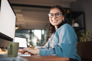 portrait of woman in office working on a website for insurance agents